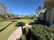 Lush backyard featuring a brick path and mature trees, ideal for outdoor relaxation and entertaining at 8503 Kentucky Derby Dr, Odessa, FL 33556