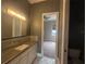 A cozy bathroom featuring a white vanity with a gray countertop and tiled backsplash at 8503 Kentucky Derby Dr, Odessa, FL 33556