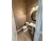 Half bath features a pedestal sink, textured wallpaper, and updated fixtures at 8503 Kentucky Derby Dr, Odessa, FL 33556