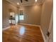 Bright bonus room with hardwood floors, a laundry area, and an archway wet bar at 8503 Kentucky Derby Dr, Odessa, FL 33556