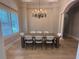 Dining room features hardwood floors, modern chandelier, and natural light at 8503 Kentucky Derby Dr, Odessa, FL 33556