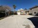 Large concrete driveway with a basketball hoop leading to a multi-car garage and home at 8503 Kentucky Derby Dr, Odessa, FL 33556