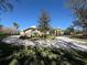 Circular driveway and manicured landscaping surrounding an elegant home at 8503 Kentucky Derby Dr, Odessa, FL 33556