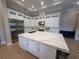 Modern kitchen featuring stainless steel appliances, white cabinetry and a large island at 8503 Kentucky Derby Dr, Odessa, FL 33556