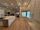 Modern kitchen with white cabinets, a large island, and stainless steel appliances at 8503 Kentucky Derby Dr, Odessa, FL 33556