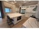 Modern kitchen features a large island, stainless steel appliances, and white cabinetry at 8503 Kentucky Derby Dr, Odessa, FL 33556