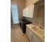 Laundry room with front-loading washer and dryer, ample counter space, and cabinets at 8503 Kentucky Derby Dr, Odessa, FL 33556