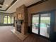 Living room with a stone fireplace, large windows, and access to the outdoor pool area at 8503 Kentucky Derby Dr, Odessa, FL 33556