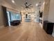 Spacious living room with hardwood floors, fireplace, and sliding glass doors to the outdoor patio at 8503 Kentucky Derby Dr, Odessa, FL 33556