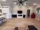 Open-concept living room with hardwood floors, fireplace, and built-in shelving at 8503 Kentucky Derby Dr, Odessa, FL 33556