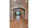 Bright living room with hardwood floors, arched doorway, and decorative pillars at 8503 Kentucky Derby Dr, Odessa, FL 33556
