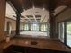 Open-concept bar area and living space with hardwood floors and natural light at 8503 Kentucky Derby Dr, Odessa, FL 33556