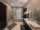Modern main bathroom with tiled shower, soaking tub, double vanity and marble countertops at 8503 Kentucky Derby Dr, Odessa, FL 33556