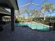 Screened-in pool area with brick pavers, featuring a relaxing pool and tropical landscaping at 8503 Kentucky Derby Dr, Odessa, FL 33556