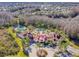 Aerial view of the community clubhouse, pools, landscaping, and surrounding nature at 19308 Sunset Bay Dr, Land O Lakes, FL 34638