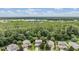Aerial view of community homes backing to mature forest; scenic view includes two lakes in background at 19308 Sunset Bay Dr, Land O Lakes, FL 34638