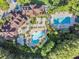 Aerial view of the community clubhouse with two swimming pools and many seating areas at 19308 Sunset Bay Dr, Land O Lakes, FL 34638