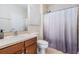 Cozy bathroom boasts a single sink vanity with wood cabinets, and a shower and bathtub combination at 19308 Sunset Bay Dr, Land O Lakes, FL 34638