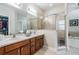 Bathroom featuring a glass enclosed shower, soaking tub, double sink vanity, and a walk-in closet at 19308 Sunset Bay Dr, Land O Lakes, FL 34638