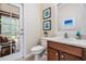 Half-bath featuring a dark wood vanity, decor and natural light at 19308 Sunset Bay Dr, Land O Lakes, FL 34638