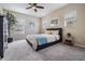 Carpeted bedroom featuring neutral decor, artwork, and natural light at 19308 Sunset Bay Dr, Land O Lakes, FL 34638