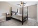Bright bedroom with a four-poster bed, ceiling fan and neutral walls at 19308 Sunset Bay Dr, Land O Lakes, FL 34638