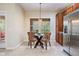 Charming breakfast nook features a round glass table and patterned chairs bathed in natural light from a nearby window at 19308 Sunset Bay Dr, Land O Lakes, FL 34638