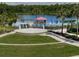 Community area with a stage, playground, lake and dock offering fun for the whole Gathering at 19308 Sunset Bay Dr, Land O Lakes, FL 34638