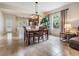 Bright dining area with tile floors, modern lighting, and views of the outdoors at 19308 Sunset Bay Dr, Land O Lakes, FL 34638