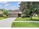 Charming two-story home with a well-manicured lawn, mature trees and two car garage at 19308 Sunset Bay Dr, Land O Lakes, FL 34638