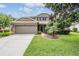 Charming two-story home with well-manicured landscaping, a two-car garage, and inviting curb appeal at 19308 Sunset Bay Dr, Land O Lakes, FL 34638