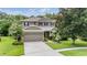 Charming two-story home with a well-manicured lawn, mature trees and two car garage at 19308 Sunset Bay Dr, Land O Lakes, FL 34638