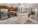 Kitchen with stainless steel appliances, breakfast bar, and open view into the living and dining area at 19308 Sunset Bay Dr, Land O Lakes, FL 34638