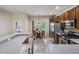 Well-lit kitchen with stainless steel appliances and adjacent breakfast nook area at 19308 Sunset Bay Dr, Land O Lakes, FL 34638