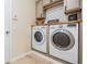 Bright laundry room with washer, dryer, and ample storage at 19308 Sunset Bay Dr, Land O Lakes, FL 34638