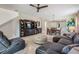 Spacious living room with media center, gray sectional, and open layout to dining area at 19308 Sunset Bay Dr, Land O Lakes, FL 34638