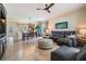 Open concept living room with large tile floors, modern ceiling fan, and neutral wall colors at 19308 Sunset Bay Dr, Land O Lakes, FL 34638