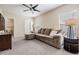 Spacious living room features a plush sectional sofa, a ceiling fan and neutral-toned decor at 19308 Sunset Bay Dr, Land O Lakes, FL 34638