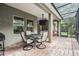 Enclosed patio with outdoor seating area, ceiling fan and mounted TV at 19308 Sunset Bay Dr, Land O Lakes, FL 34638