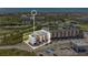 Aerial view of newly constructed townhomes with modern design, surrounded by lush greenery and waterfront views at 2 Aqua Reserve Blvd, New Port Richey, FL 34652