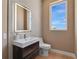Modern bathroom featuring vanity, sink and illuminated mirror, and tiled walls at 2 Aqua Reserve Blvd, New Port Richey, FL 34652