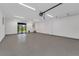 Spacious garage with epoxy flooring, ample lighting, a utility sink and an exit door to the exterior at 2 Aqua Reserve Blvd, New Port Richey, FL 34652