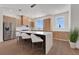 Modern kitchen with stainless appliances, white countertops, wood cabinets, and island seating at 2 Aqua Reserve Blvd, New Port Richey, FL 34652