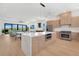 Bright, open kitchen featuring a large island, stainless steel appliances, and modern wood cabinets at 2 Aqua Reserve Blvd, New Port Richey, FL 34652