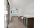 Bright living area featuring a wet bar with a wine fridge, light wood floors and sliding glass doors at 2 Aqua Reserve Blvd, New Port Richey, FL 34652