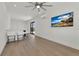 Modern living area featuring light wood floors, white walls, a wet bar, and a wall-mounted television at 2 Aqua Reserve Blvd, New Port Richey, FL 34652