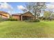 Expansive backyard featuring a well maintained lawn and a beautiful mature tree at 20312 Heritage Point Dr, Tampa, FL 33647