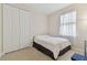 Cozy bedroom features neutral carpet, bright window, and closet, creating a peaceful retreat perfect for relaxation at 20312 Heritage Point Dr, Tampa, FL 33647