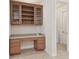 Convenient desk with upper cabinets provides a dedicated workspace and easy access to laundry room, enhancing home functionality at 20312 Heritage Point Dr, Tampa, FL 33647