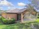 A view of the property’s exterior and screened lanai with a neatly landscaped yard at 20312 Heritage Point Dr, Tampa, FL 33647